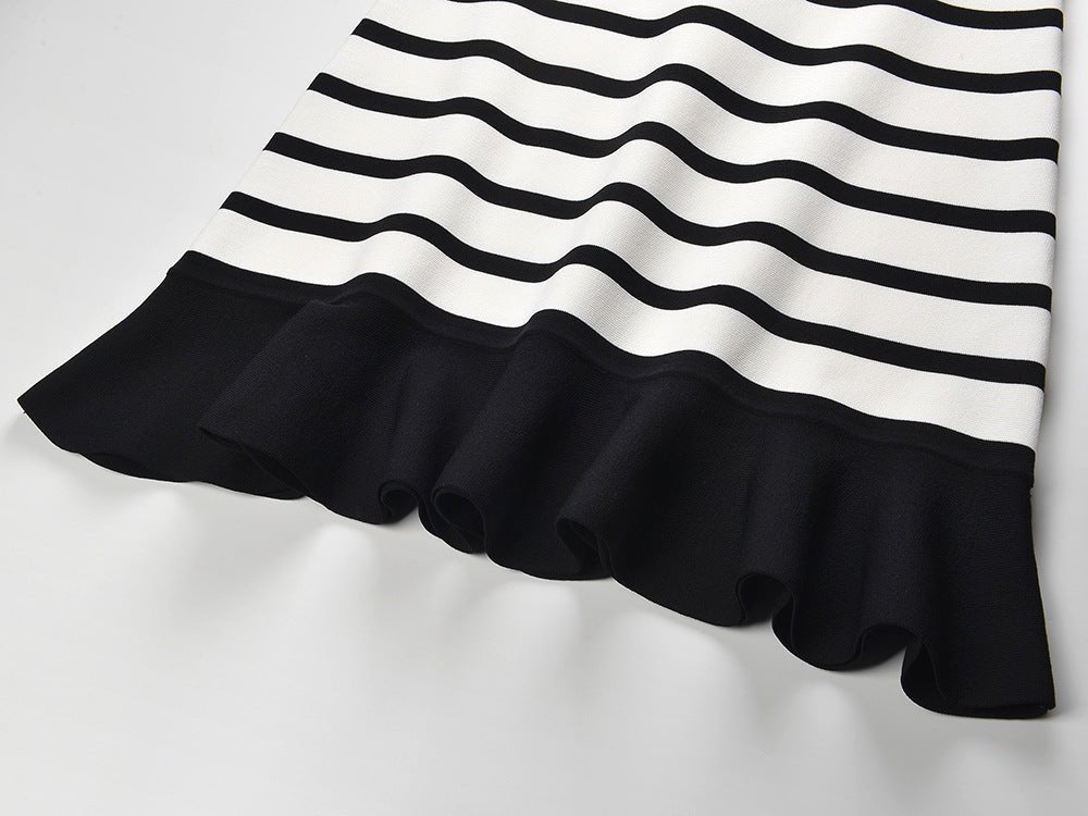 Black and white striped sleeveless body-con knit top with gold button accents on shoulders