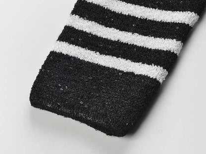 Black and white striped fitted knit cardigan with gold-tone buttons