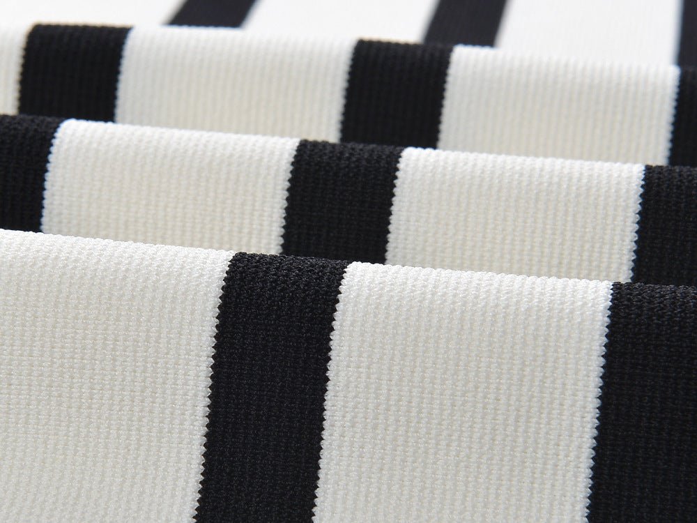 Black and white striped sleeveless body-con knit top with gold button accents on shoulders