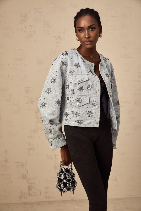 Blue denim jacket with sun motif and studs featuring Katell design