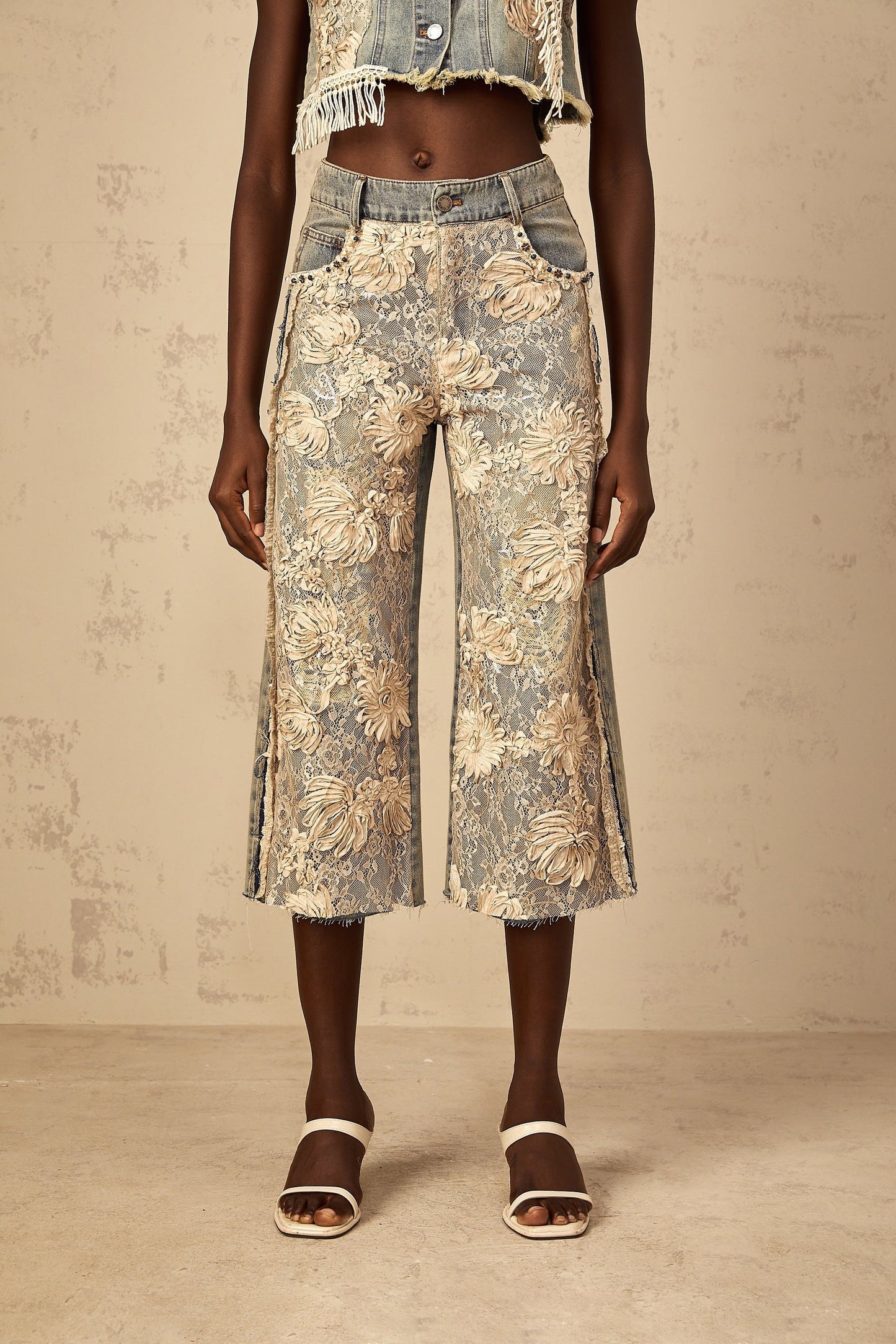 Blue denim jeans with floral lace panels in an amaryllis pattern