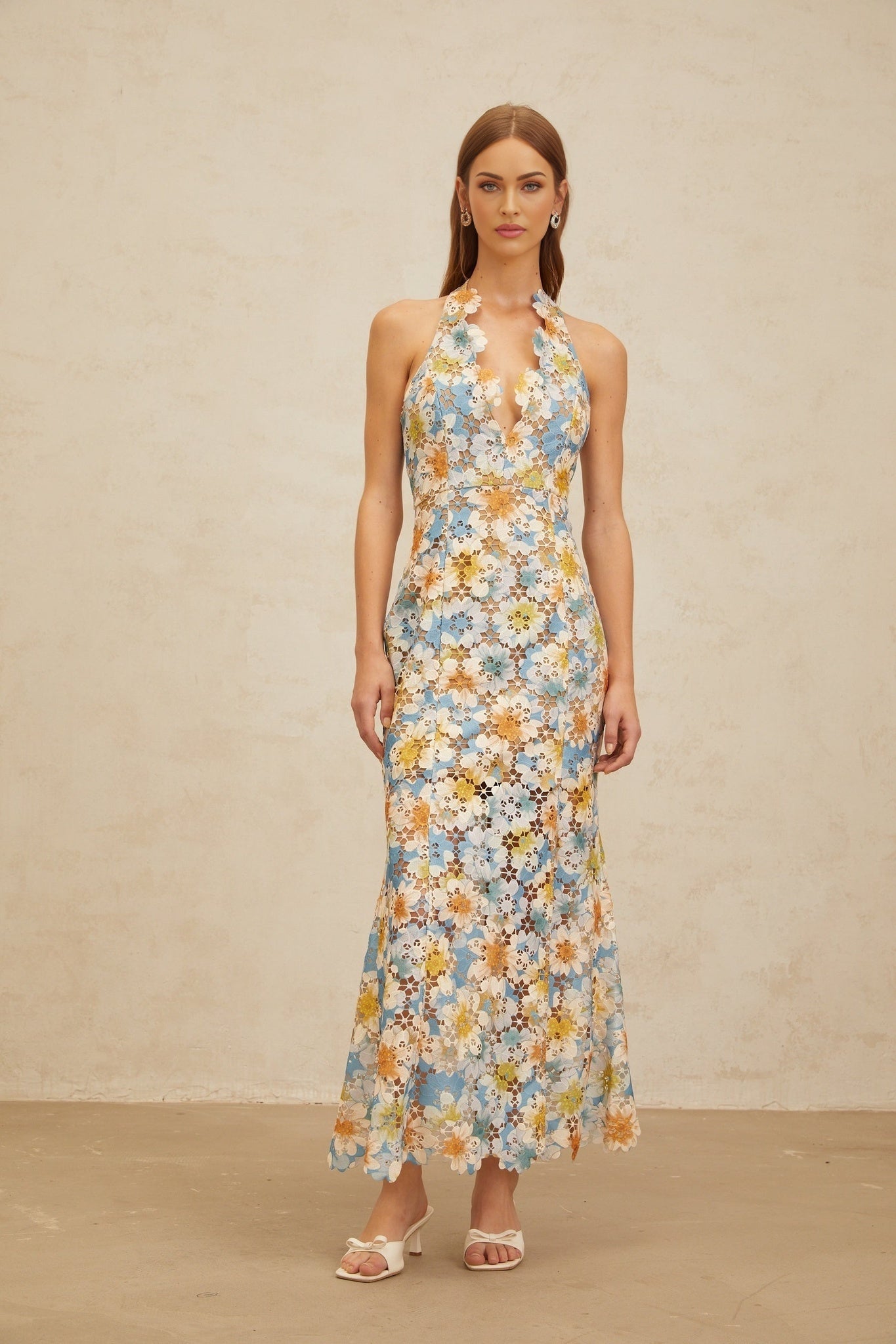 Blue halterneck sleeveless maxi dress with floral embroidery and cut-out design
