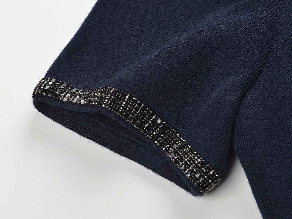 Blue knit two-piece suit with decorative buttons and timeless elegance