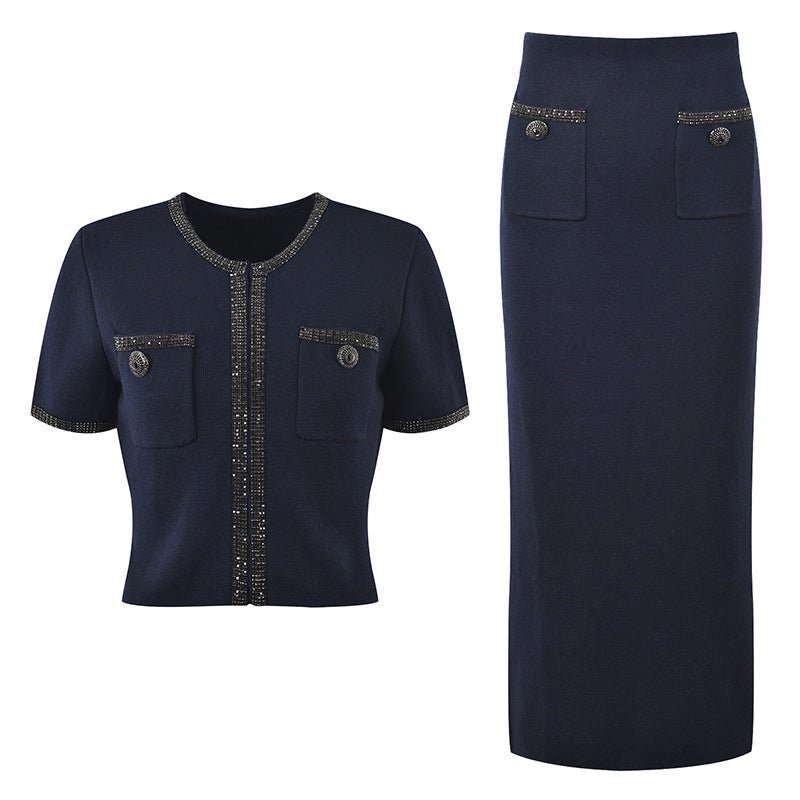 Blue knit two-piece suit with decorative buttons and embellishments