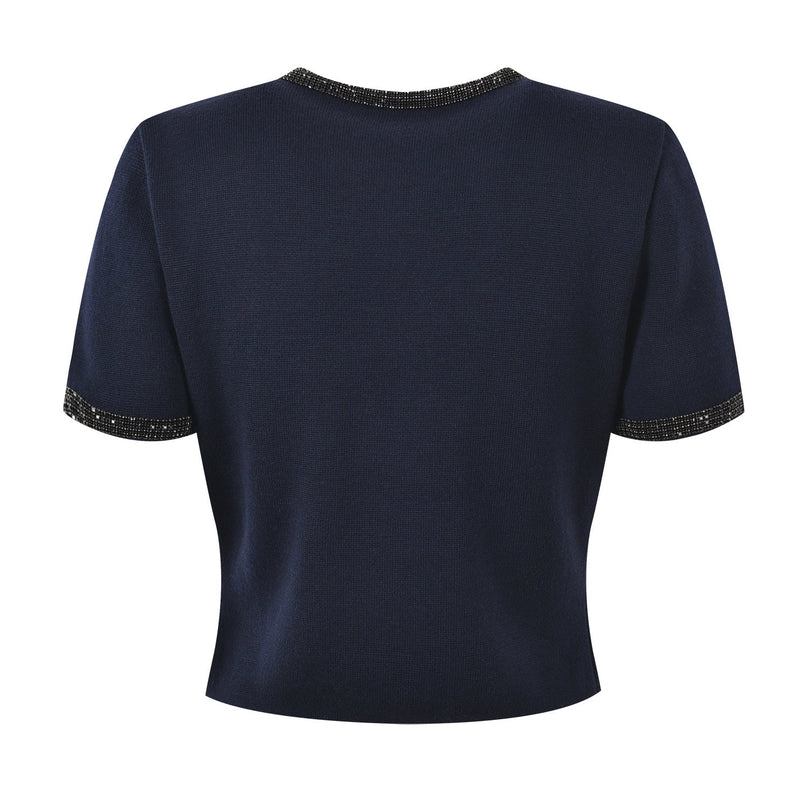 Blue knit two-piece suit with decorative buttons and embellishments