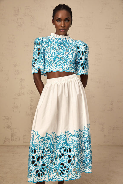 Blue matching set with embroidered top and skirt featuring cutout details
