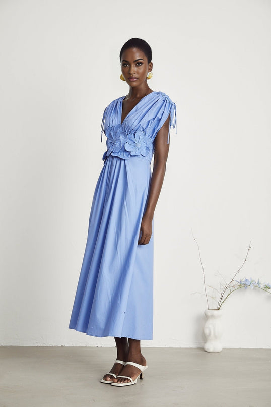 Blue maxi dress with floral petal details and drawstring waist named Emma