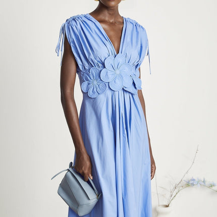 Blue maxi dress with floral petal details and drawstring waist named Emma