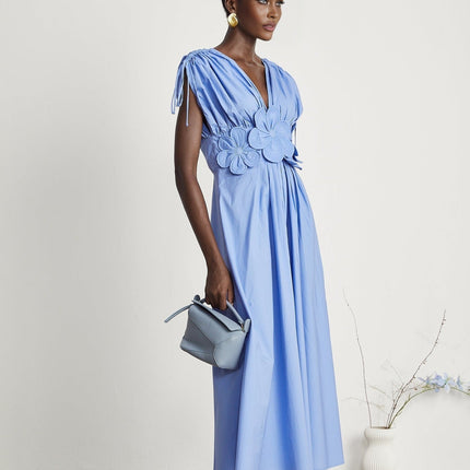 Blue maxi dress with floral petal details and drawstring waist named Emma