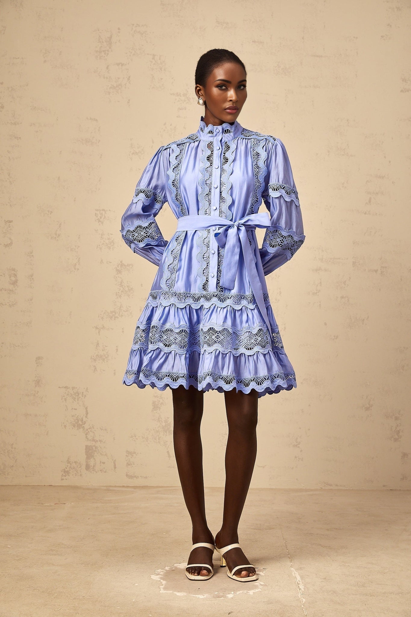 Blue mini dress with tiered skirt and cutout embroidery details featuring floral motifs
