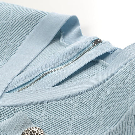Blue ribbed knit button-front dress with metallic buttons and pocket accents