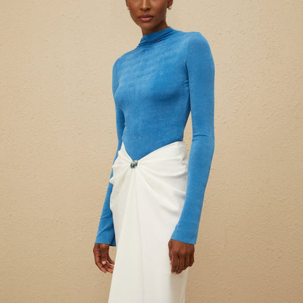 Blue turtleneck bodysuit with long sleeves and fitted silhouette