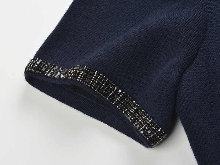 Blue two-piece suit with decorative buttons and embellishments