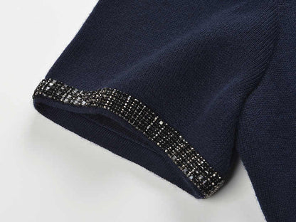 Blue two-piece suit with decorative buttons and embellishments