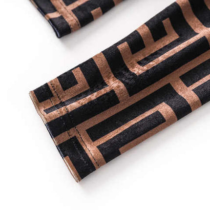 Brown geometric logo print slim fit long sleeve top in black and warm beige tones with high neck detail and back zipper closure, suitable for fall and winter