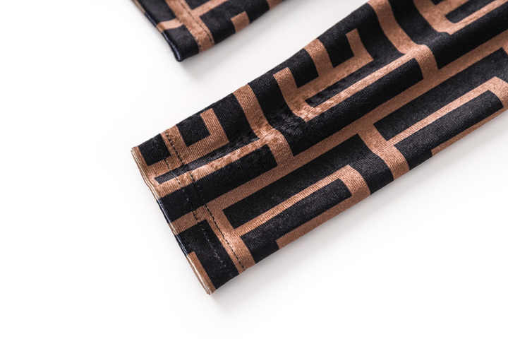 Brown geometric logo print slim fit long sleeve top in black and warm beige tones with high neck detail and back zipper closure, suitable for fall and winter