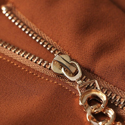 Brown high-waisted flared-leg pants with gold chain embellishment