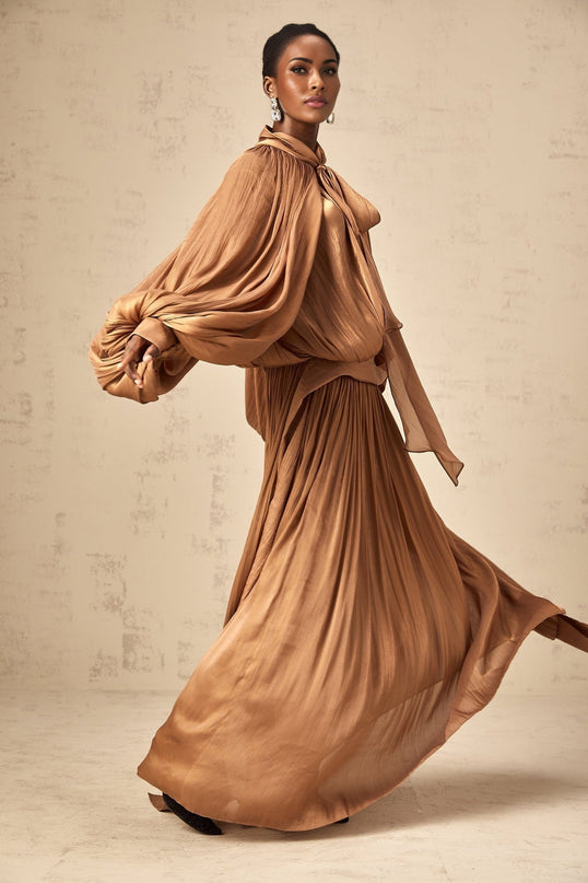 Brown pleated satin maxi dress with long skirt and flowing silhouette