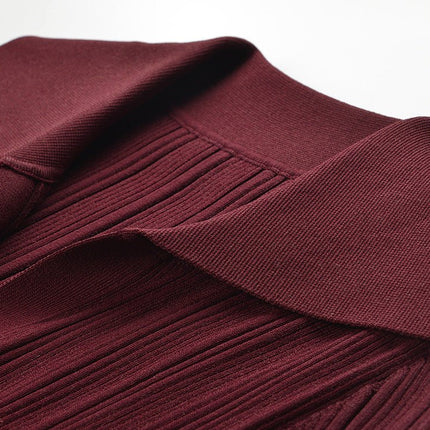 Burgundy fitted knit sweater with button details and flared sleeves