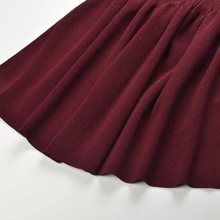 Burgundy fitted silhouette with flare at bottom ribbed knit cardigan with button details tailored fit accentuating curves versatile for layering or standalone ideal for fall or winter wear soft stretchy fabric notched collar and flared sleeves suitable for formal or semi-formal events modern and chic with vintage appeal