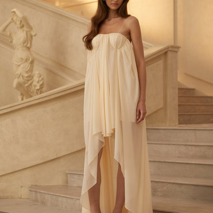 Carmela Midi Dress in Neutrals Beige Chiffon Mullet Hem Open Back Asymmetrical Cut Pleated Silhouette