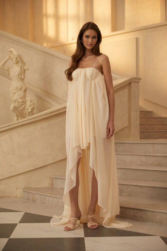 Carmela Midi Dress in Neutrals Beige Chiffon Mullet Hem Open Back Asymmetrical Cut Pleated Silhouette
