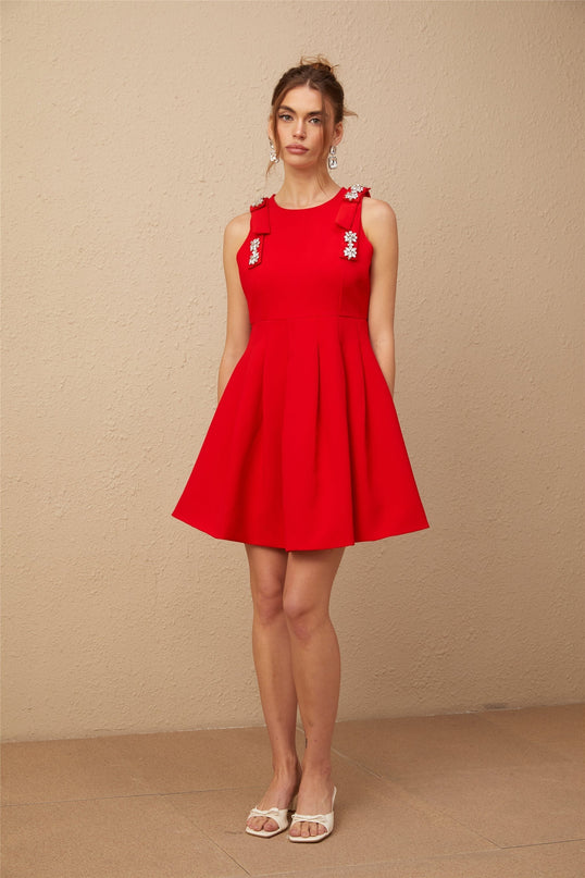 Caroline Red Textured Mini Dress Crystal Embellishment Bow Detailing Pleated Skirt Sleeveless Round Neck Thigh Length Rear Zip Fastening