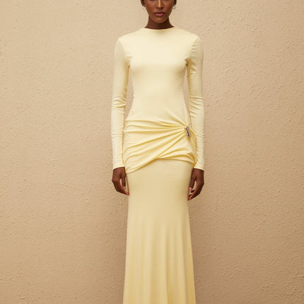 Charlotte Maxi Dress in Yellow with crew neck and long sleeves, fitted waistline, flared hem, gathered detailing, shirred panel, embossed silver-tone hardware, rear slit, and zip fastening