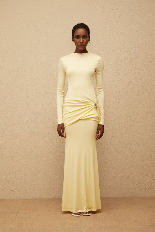 Charlotte Maxi Dress in Yellow with crew neck and long sleeves, fitted waistline, flared hem, gathered detailing, shirred panel, embossed silver-tone hardware, rear slit, and zip fastening