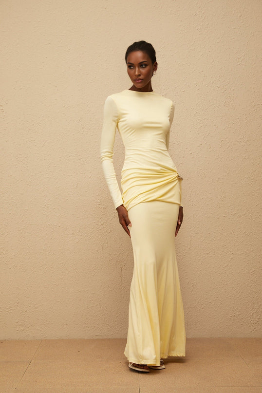 Charlotte Maxi Dress in Yellow with crew neck, long sleeves, fitted waistline, flared hem, gathered detailing, shirred panel, embossed silver-tone hardware, rear slit, and zip fastening
