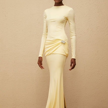 Charlotte Maxi Dress in Yellow with crew neck, long sleeves, fitted waistline, flared hem, gathered detailing, shirred panel, embossed silver-tone hardware, rear slit, and zip fastening