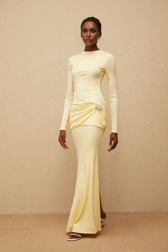 Charlotte Maxi Dress in Yellow with crew neck, long sleeves, fitted waistline, flared hem, gathered detailing, shirred panel, embossed silver-tone hardware, rear slit, and zip fastening