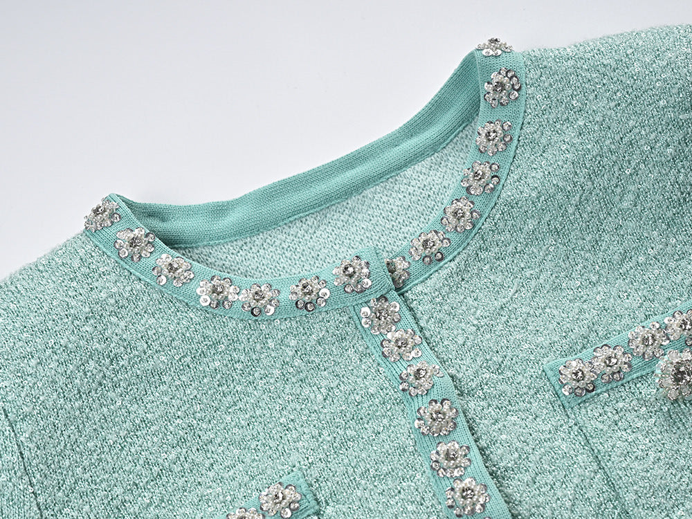 Clara wearing green tweed jacket and pleated skirt set