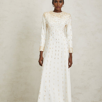 Clara Maxi Dress in White with sequin, faux-pearl, and crystal embellishments, rear zip fastening, and voluminous skirt