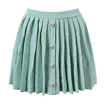 Clara wearing mint green tweed jacket and pleated skirt set with floral embellishments and pearl buttons