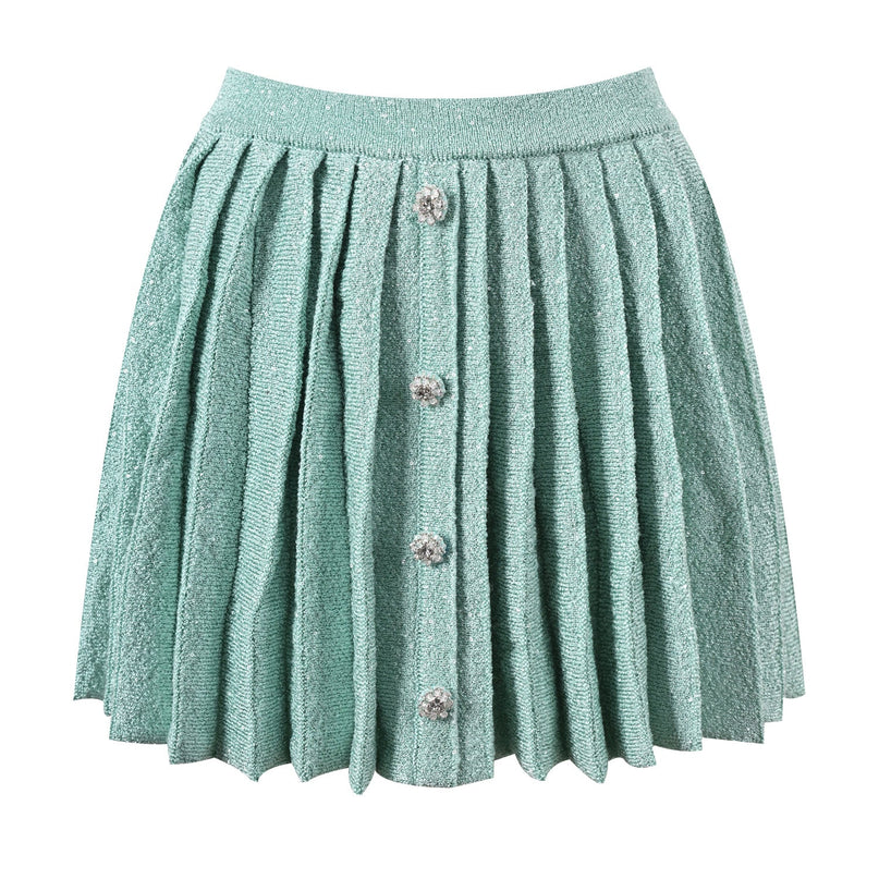 Clara wearing mint green tweed jacket and pleated skirt set with floral embellishments and pearl buttons