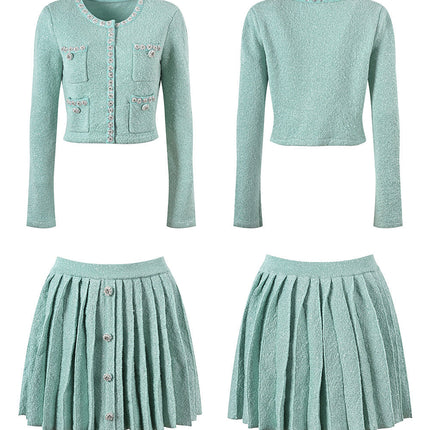 Clara wearing mint green tweed jacket and pleated skirt set with floral embellishments and pearl buttons