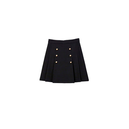 White tweed jacket with pearl buttons and contrasting cuffs, paired with a pleated black high-waisted skirt