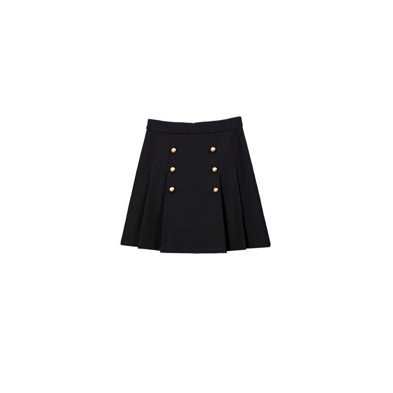 White tweed jacket with pearl buttons and contrasting cuffs, paired with a pleated black high-waisted skirt