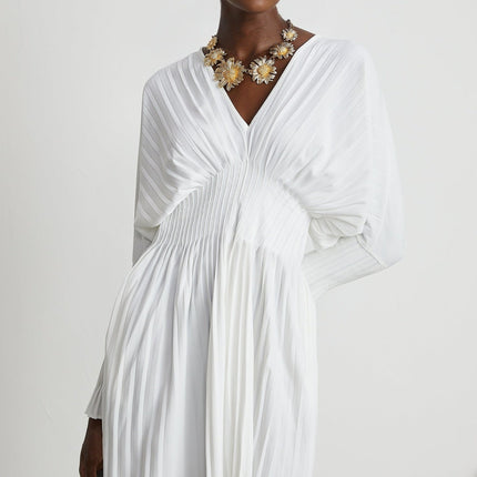 Claudette White Pleated Mini Dress V-neckline Flared Cuffs Long Sleeves Textured Finish Lacing Detail Waist Polyester Cotton Blend Light Airy Elegant Summer Chic Gatherings Flowy Mini Length Versatile Timeless