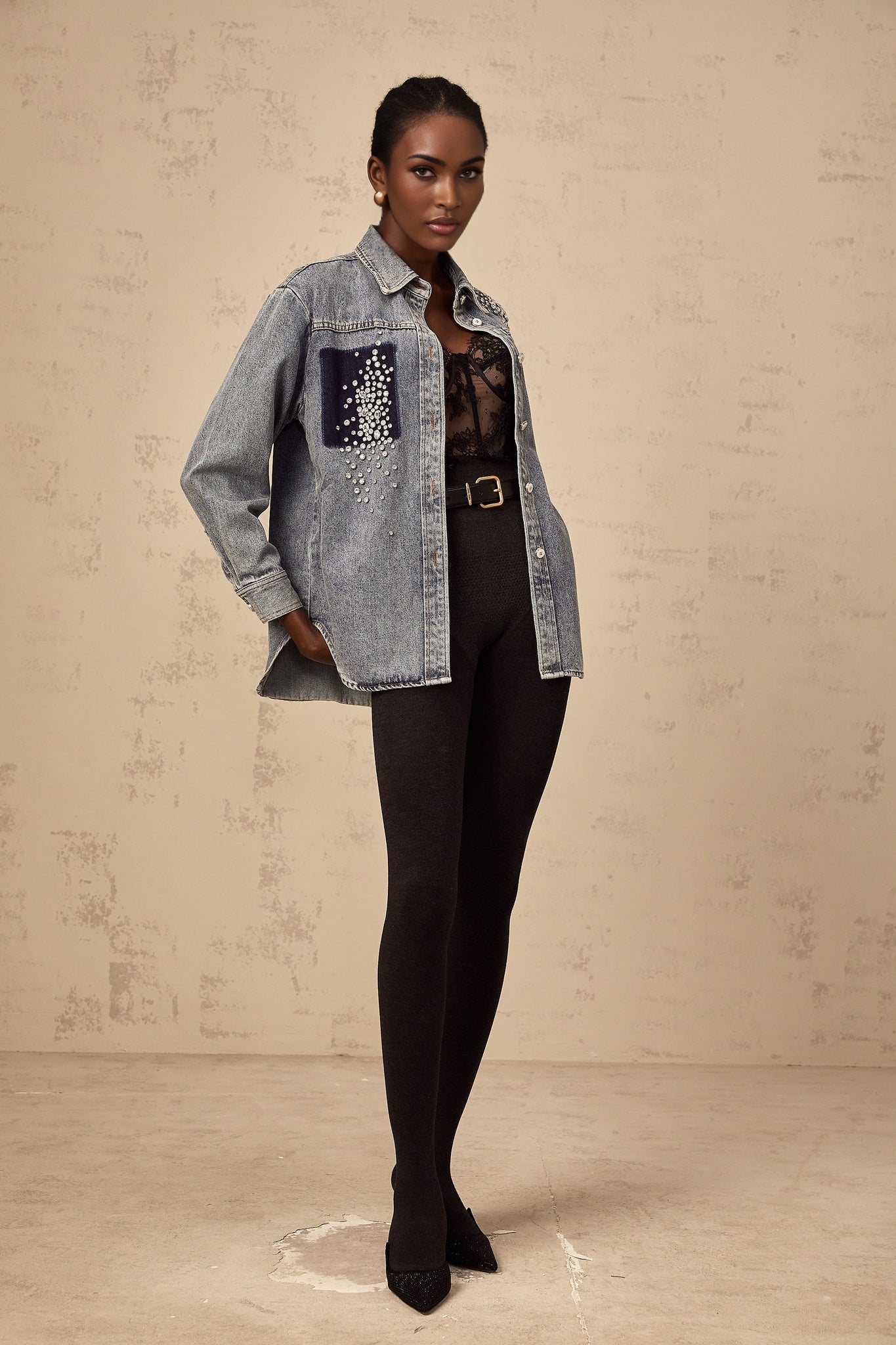 Closeup of light blue denim shirt with small rhinestone embellishments scattered across the fabric Ségolène brand visible on collar