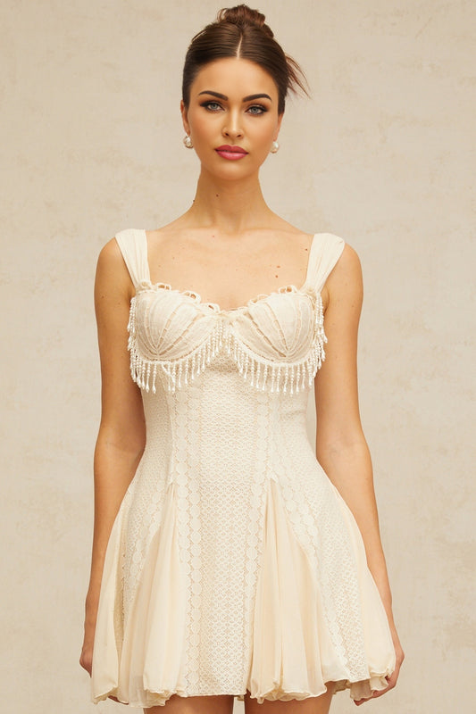 Creamwhite mini dress with flared skirt and embellished details named Calliopee