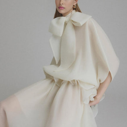 Dakota Cream White Maxi Dress with Tied Neck and Batwing Sleeves Ruffled Pleat Design Partial Lining and Pleated Detailing 100% Terylene Fiber Semi-Sheer Construction and Maxi Length for Sophisticated Occasions