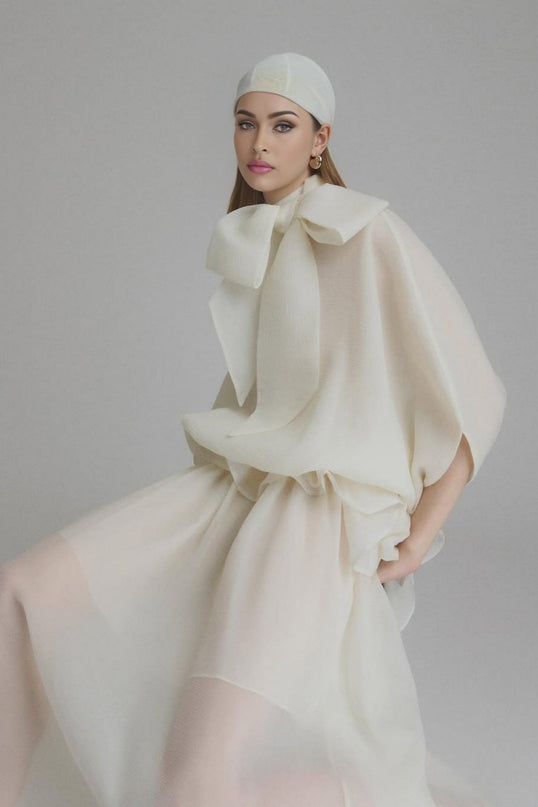 Dakota Cream White Maxi Dress with Tied Neck and Batwing Sleeves Ruffled Pleat Design Partial Lining and Pleated Detailing 100% Terylene Fiber Semi-Sheer Construction and Maxi Length for Sophisticated Occasions