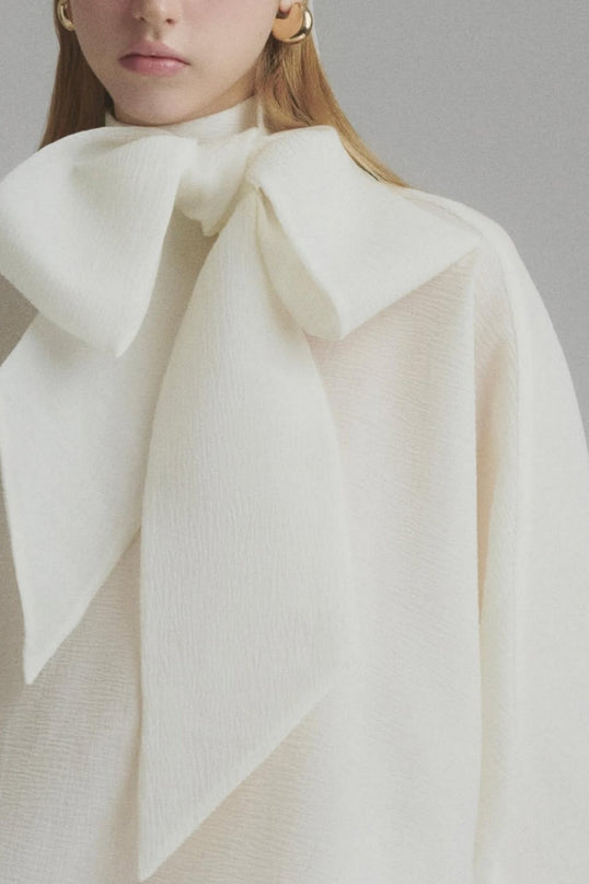Dakota Cream White Maxi Dress Tied Neck Batwing Sleeves Ruffled Pleat Design Partial Lining Pleated Detailing Luxurious Terylene Fiber Semi-Sheer Construction Maxi Length Elegant Sophisticated Whimsical Charm Versatile Feminine Grace Soiree Garden Party Timeless Style Modern Elegance