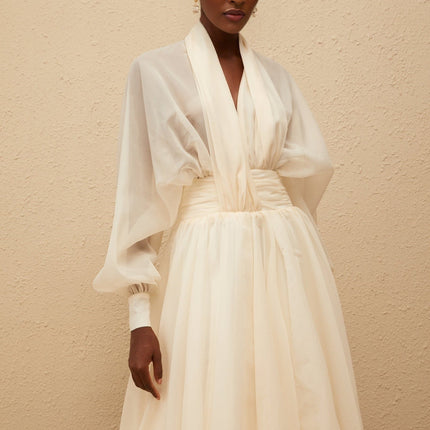 Daniela Maxi Dress in Cream White with V-neck, long puff sleeves, cinched waist, tulle fabric, draped design, and bubble hem