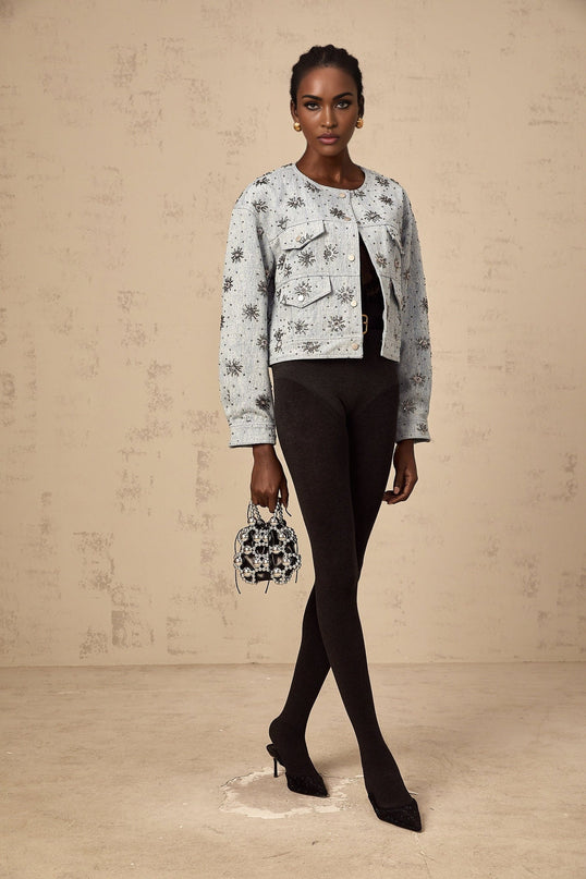 Denim jacket in blue color with sun pattern design and studded details