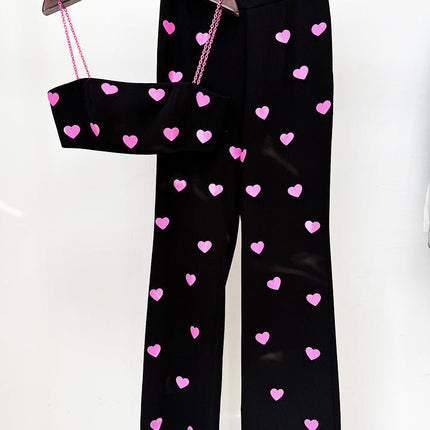 Dylan wearing Black Heart Pattern Cropped Top and Flared Pants with Pink Accents