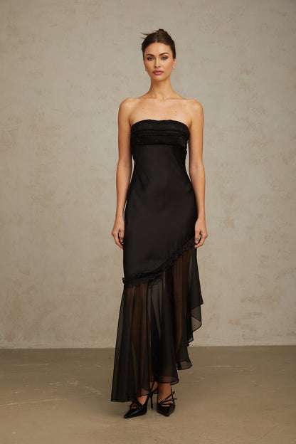 Elegant black maxi dress featuring satin fabric with sheer tulle panels long sleeves and a flowing skirt