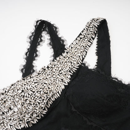 Black floorlength dress with lace overlay sleeveless crystal embellishment and crossover asymmetrical design showcasing a rear zip fastening